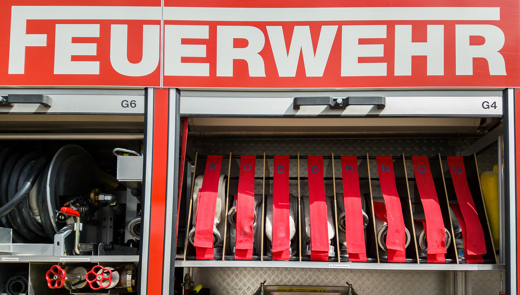 German fire engine truck with open doors Der Kommandant der Feuerwehr
